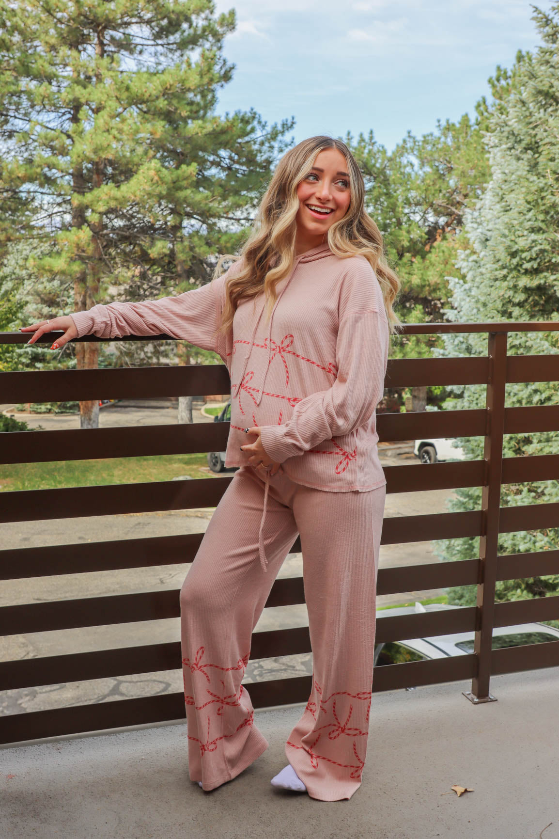 girl wearing tan candy cane heart pajamas