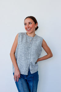 girl wearing grey knit sleeveless cardigan top