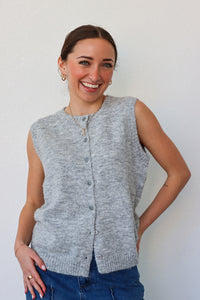 girl wearing grey knit sleeveless cardigan top