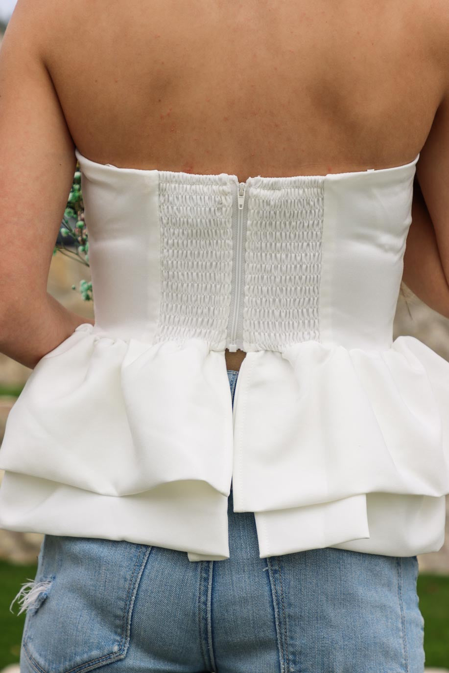 back zipper on strapless white peplum top