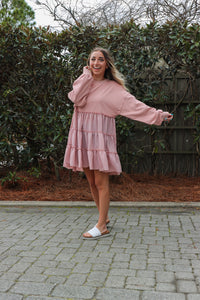 girl wearing pastel pink long sleeve tulle dress
