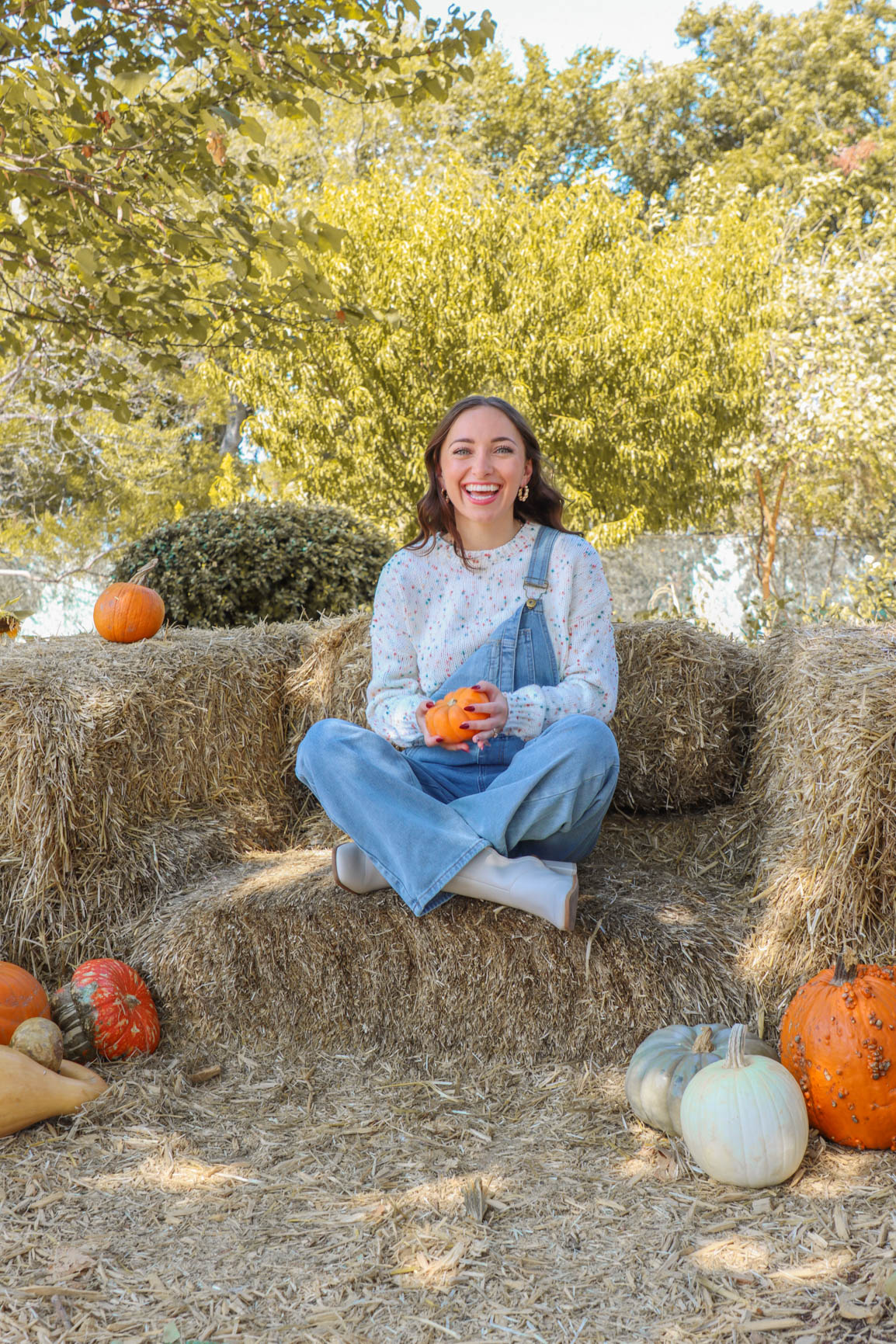 girl wearing light wash denim overalls