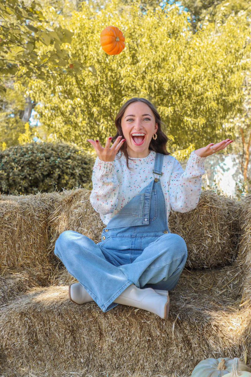 girl wearing light wash denim overalls