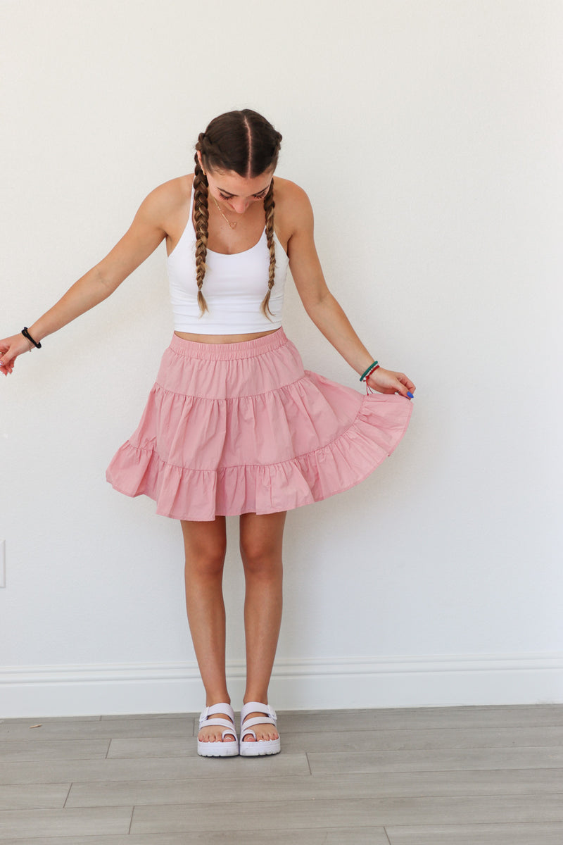 girl wearing pink athletic tiered skirt