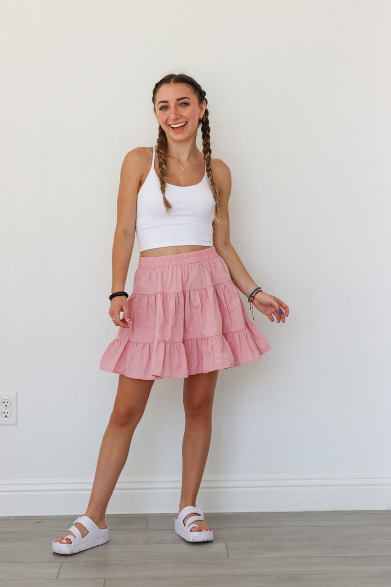 girl wearing pink athletic tiered skirt