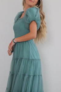 girl wearing green long dress with tulle detailing