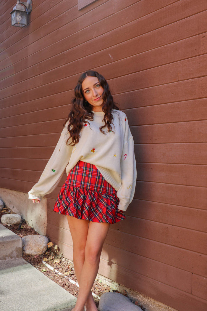 girl wearing cream embroidered holiday sweater