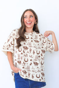 Woman wearing a white t-shirt with brown graphics on a white background