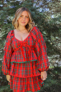 girl wearing red plaid holiday dress