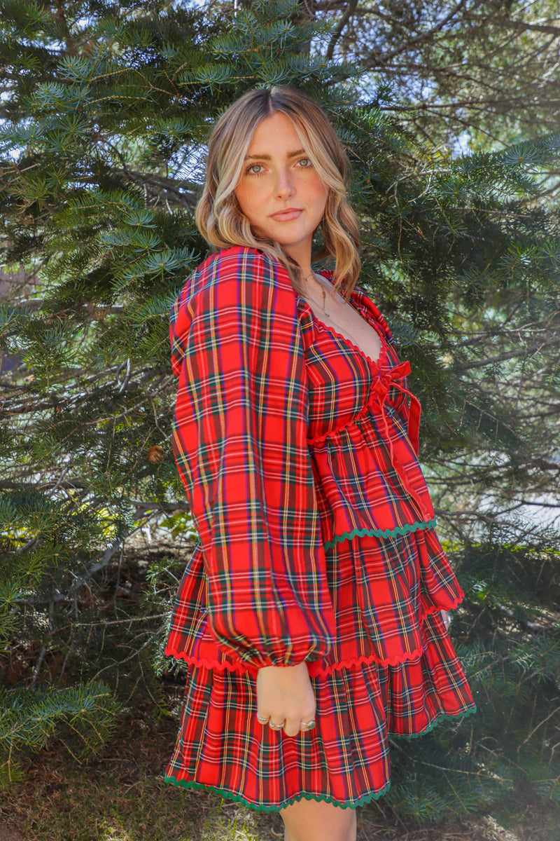 girl wearing red plaid holiday dress