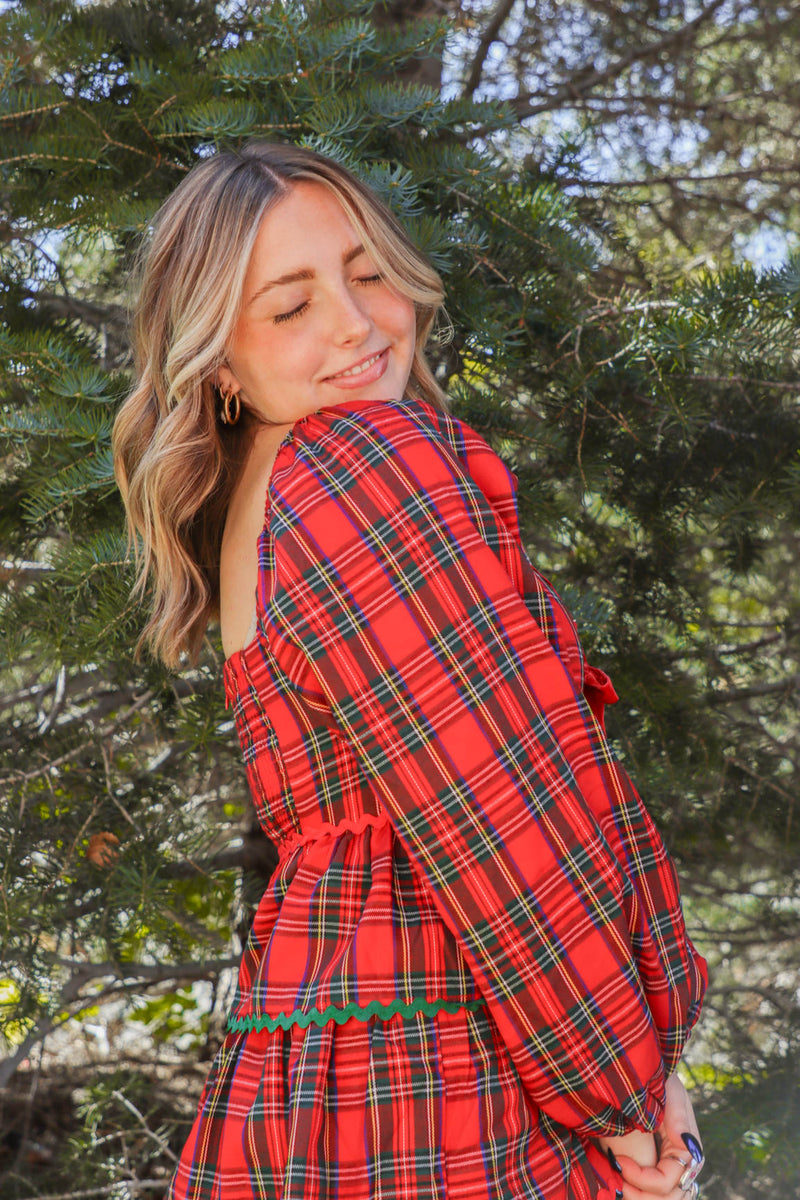 girl wearing red plaid holiday dress