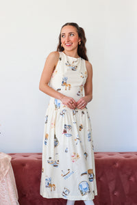 Woman wearing a white sleeveless dress with animal prints against a plain background