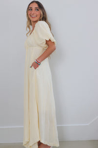 girl wearing cream long dress with puff sleeves