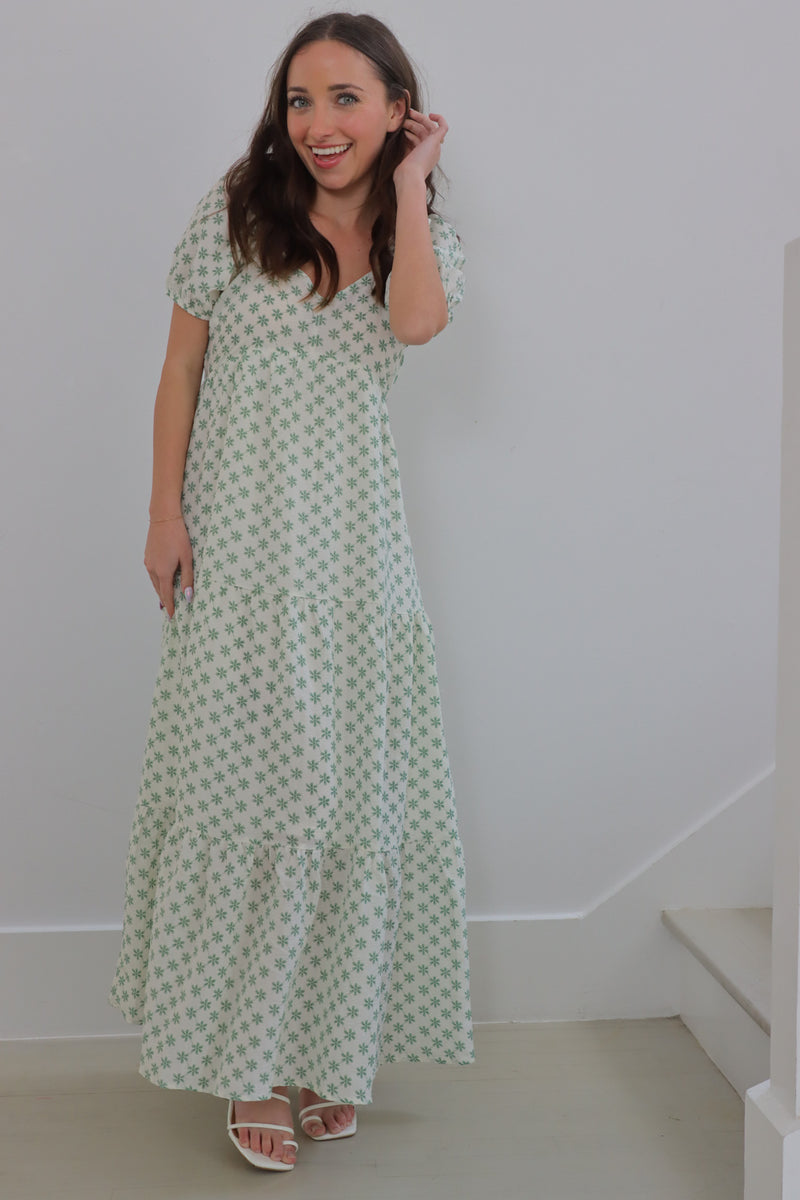 girl wearing cream long dress with green flowers