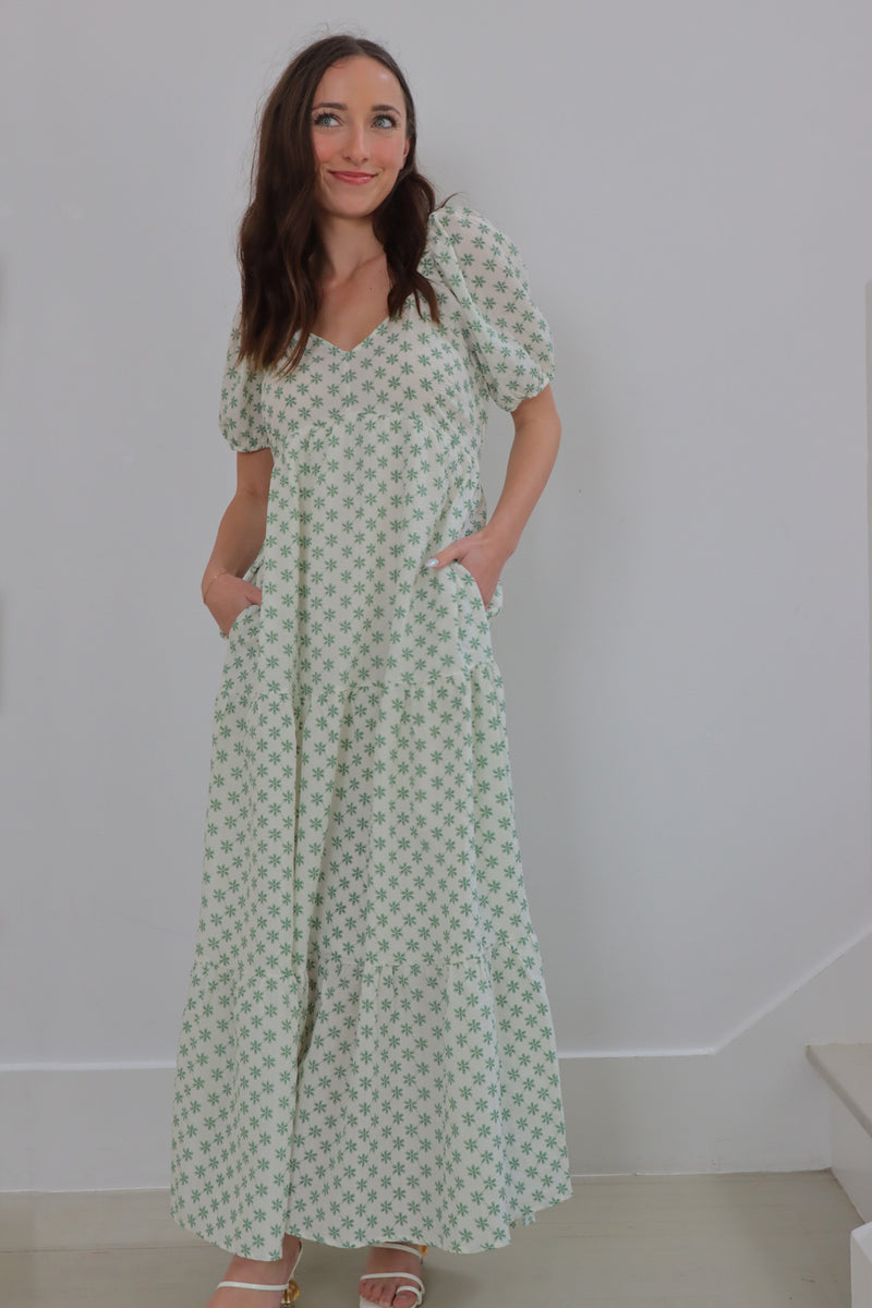 girl wearing cream long dress with green flowers