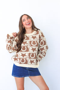Woman wearing a patterned sweater and denim skirt on a white background