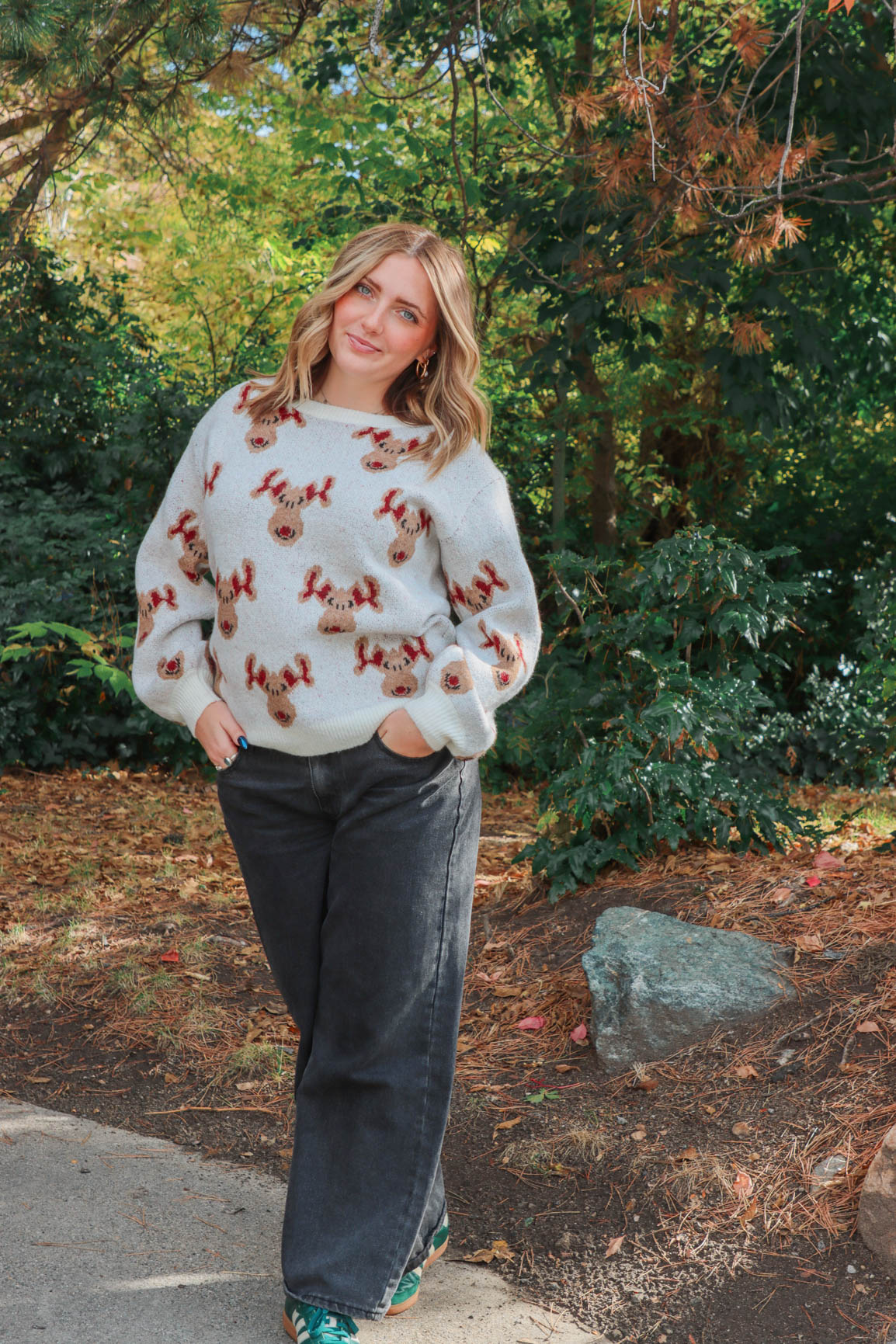 girl wearing knit reindeer sweater