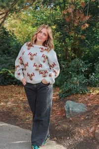 girl wearing knit reindeer sweater