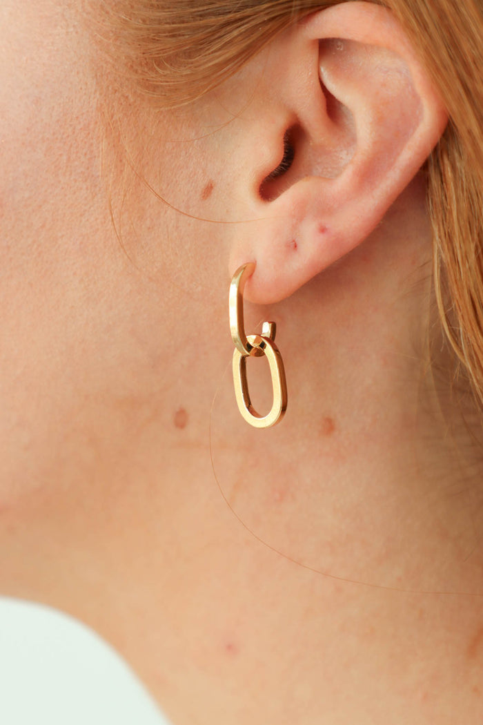 girl wearing gold hoop earrings