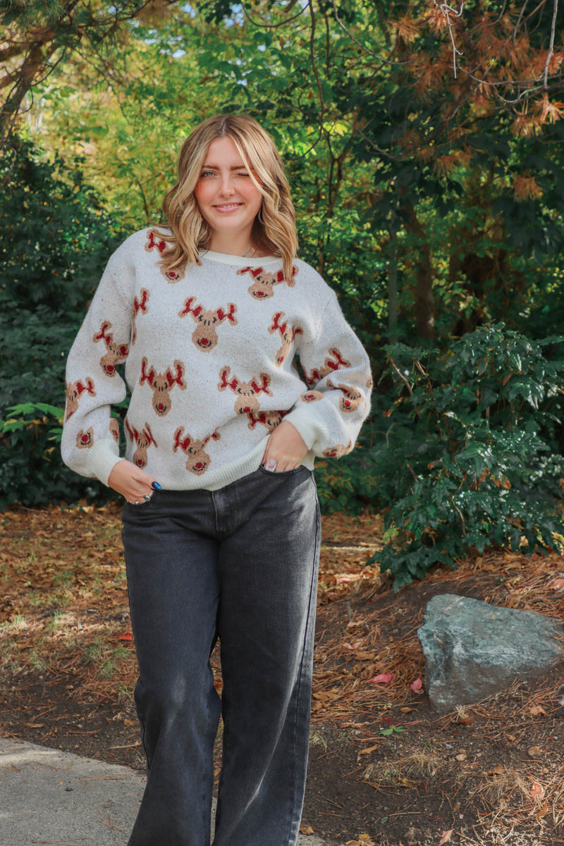 girl wearing knit reindeer sweater