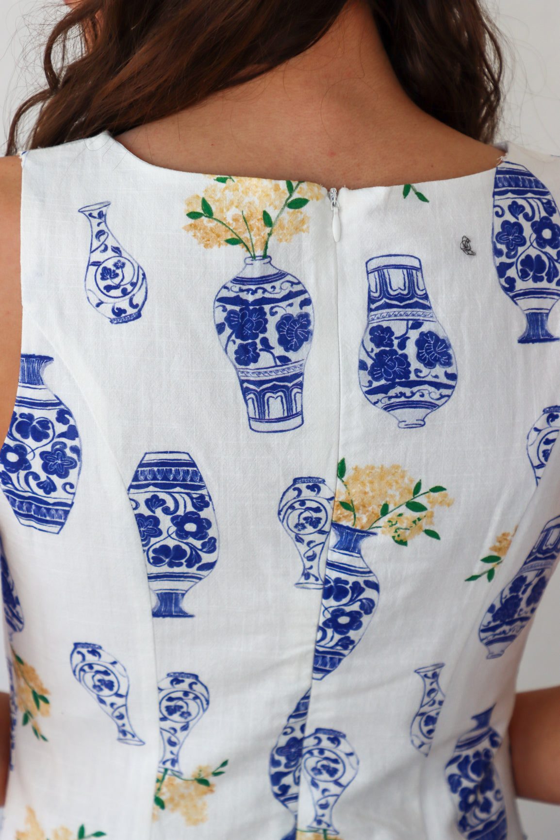 White sleeveless top with blue and yellow floral pattern