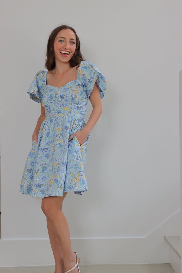 girl wearing light blue floral short dress