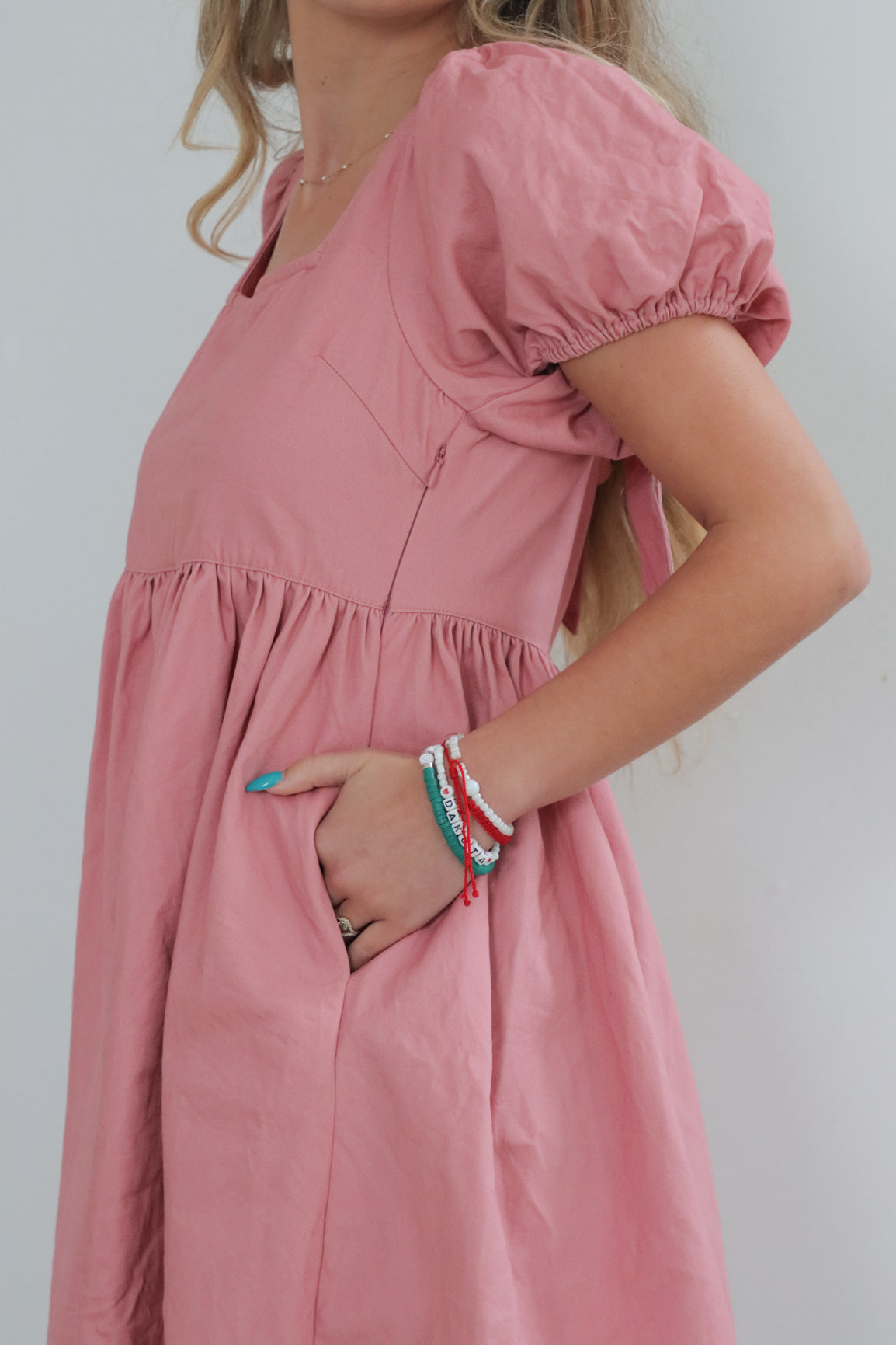 girl wearing pink babydoll dress