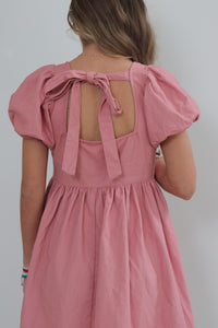 girl wearing pink babydoll dress