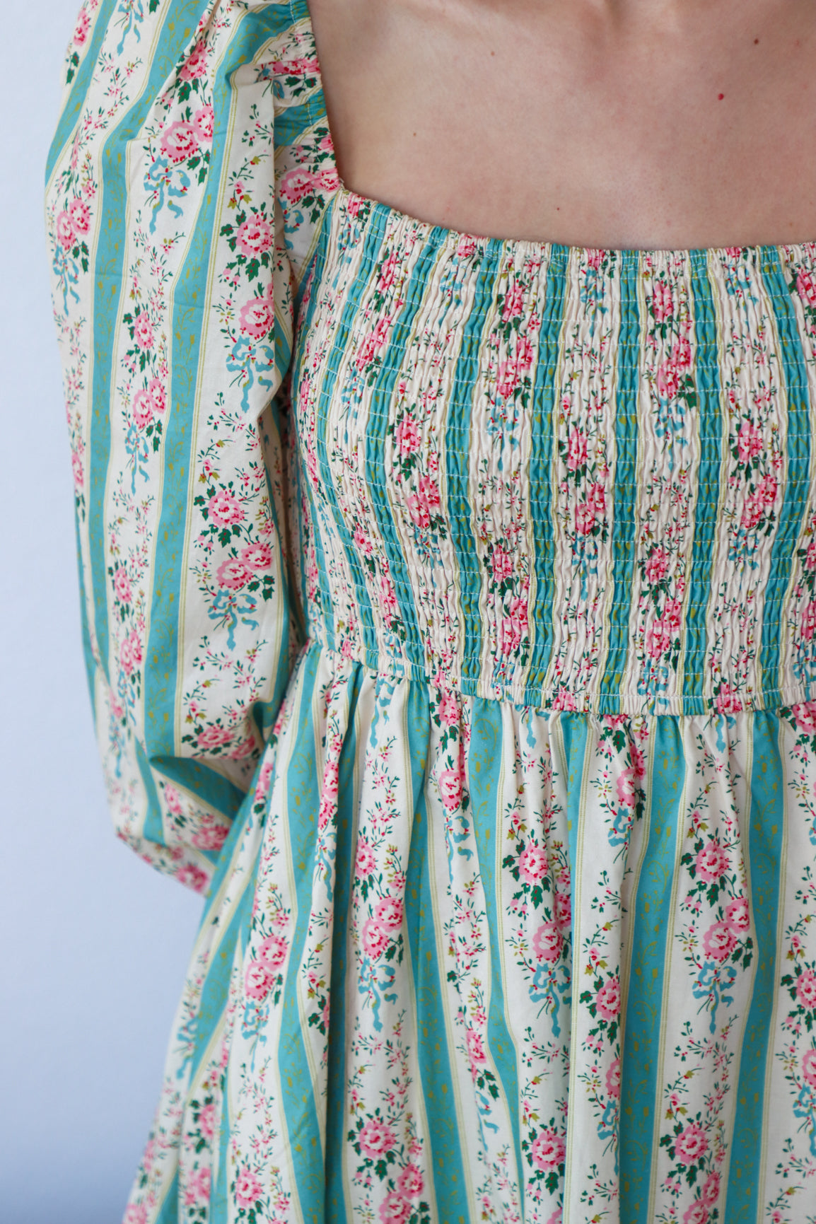 Floral and striped dress with a plain background