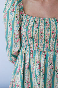 Floral and striped dress with a plain background