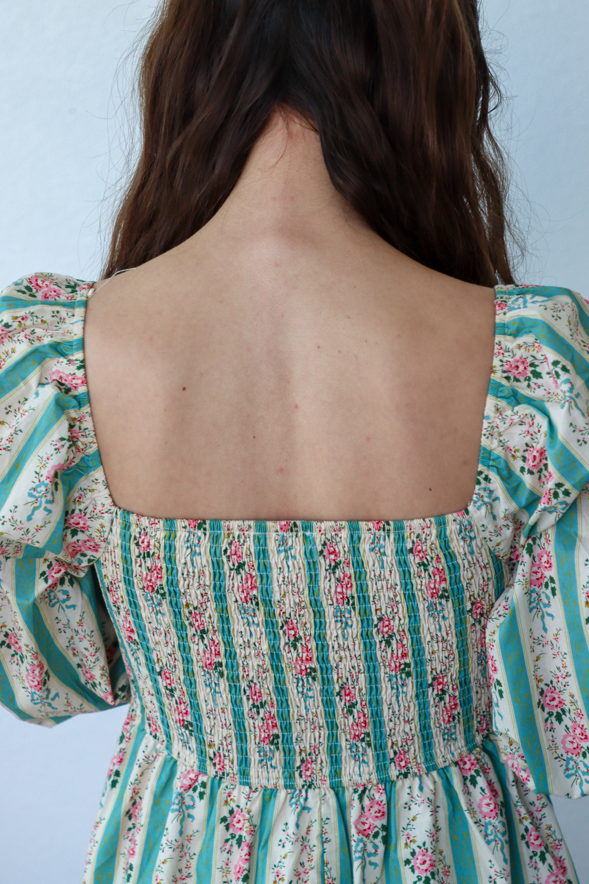 Floral and striped dress with a plain background