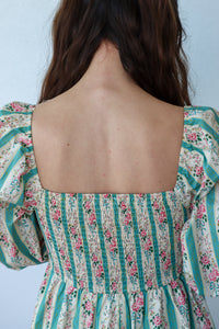 Floral and striped dress with a plain background