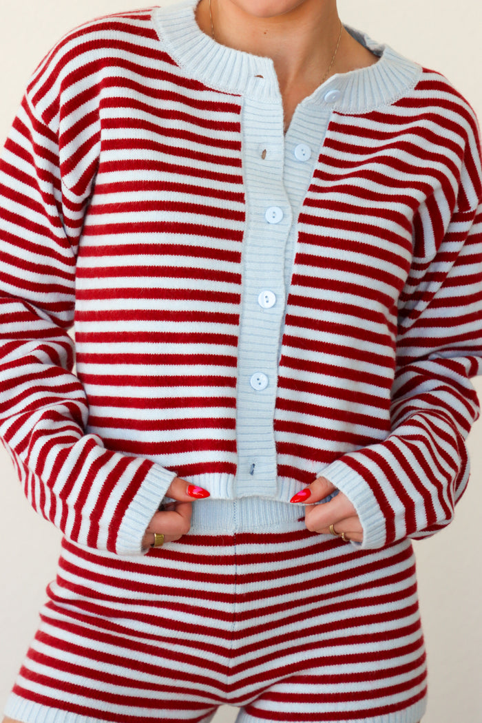 Red and white striped outfit with a matching cardigan and shorts on a plain background