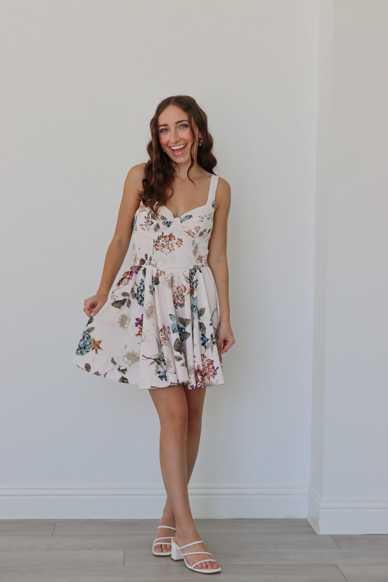 girl wearing white short dress with multicolored floral print