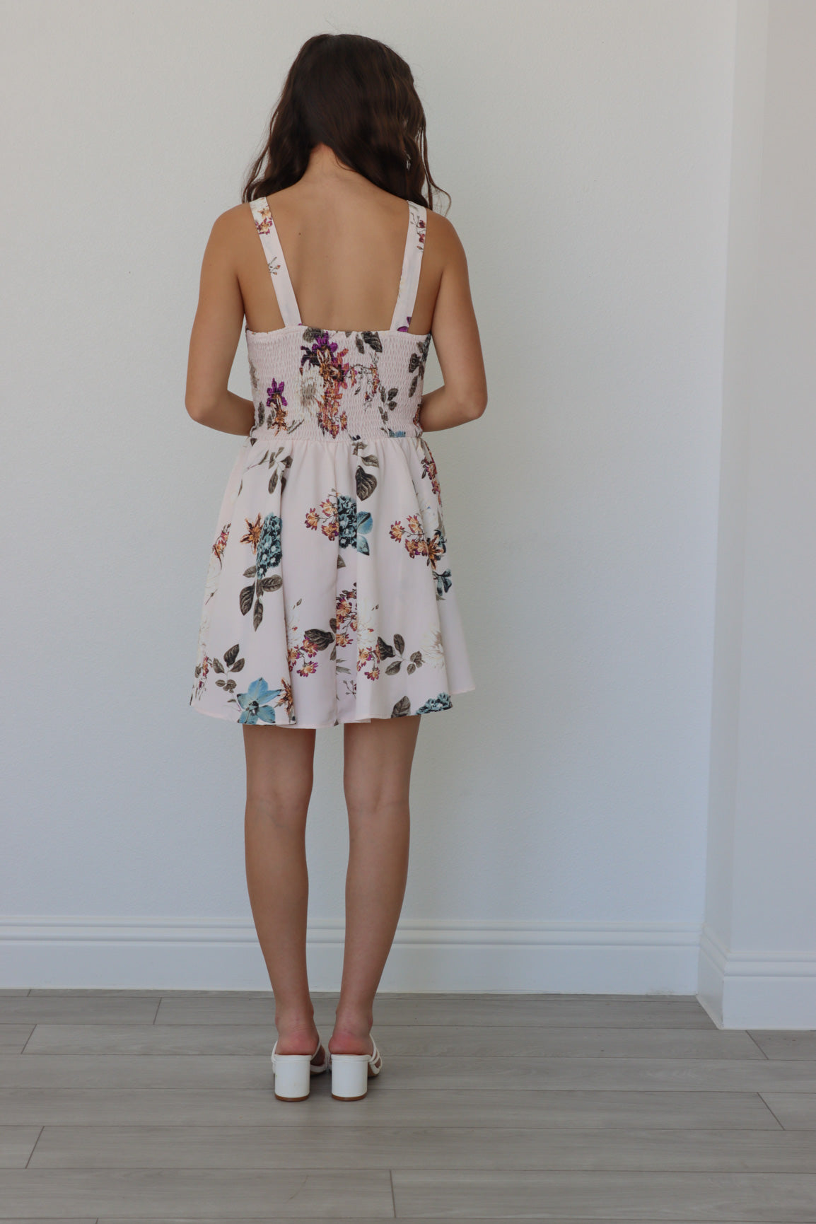 girl wearing white short dress with multicolored floral print