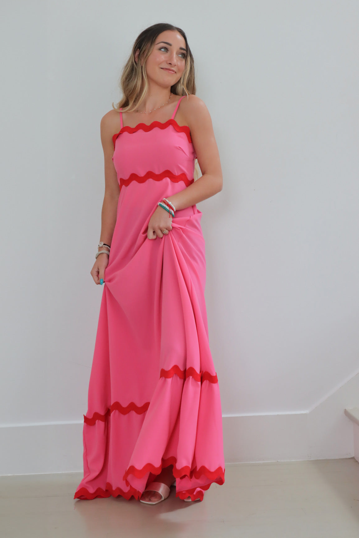 girl wearing pink long dress with chevron detailing