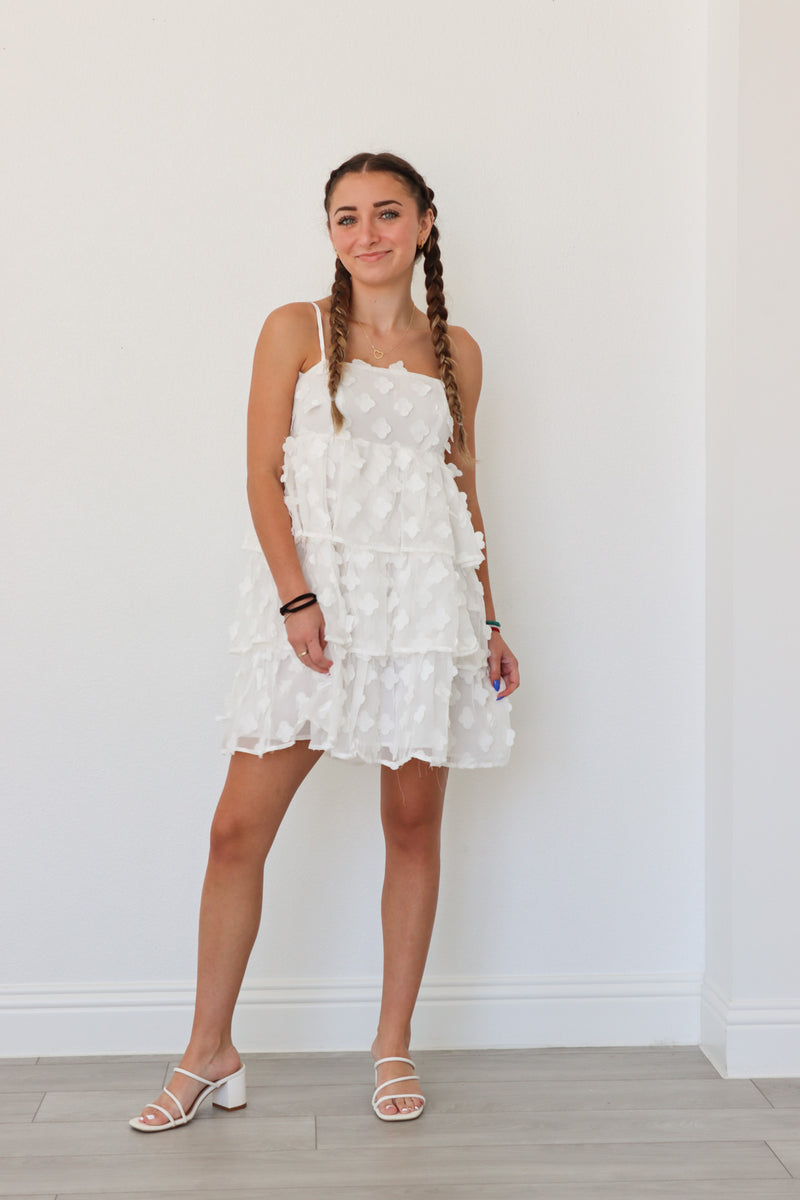 girl wearing short white floral dress