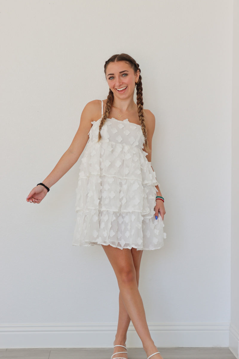 girl wearing short white floral dress