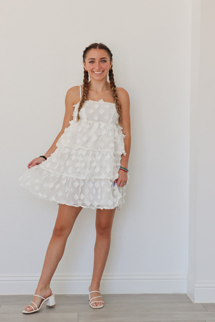 girl wearing short white floral dress