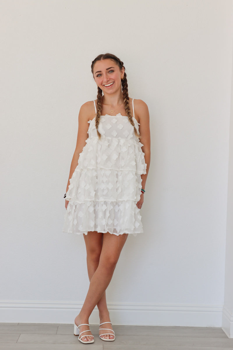 girl wearing short white floral dress