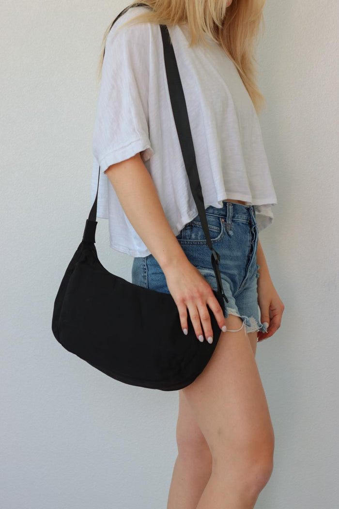 girl carrying black nylon bag