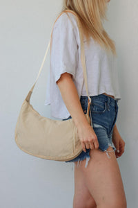 girl carrying cream nylon bag
