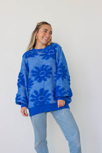 girl wearing royal blue floral sweater