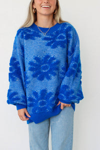 girl wearing royal blue floral sweater