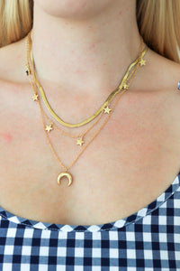 Woman wearing a white dress against a plain white wall