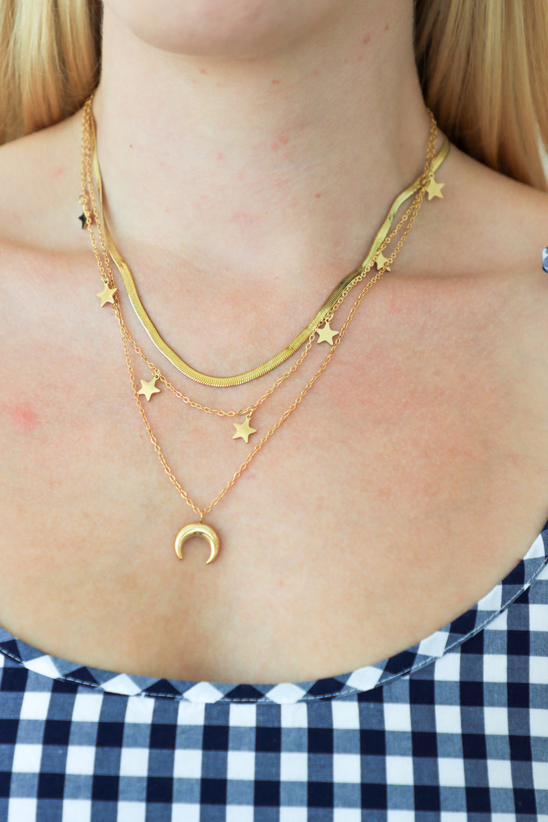 Woman wearing a white dress against a plain white wall