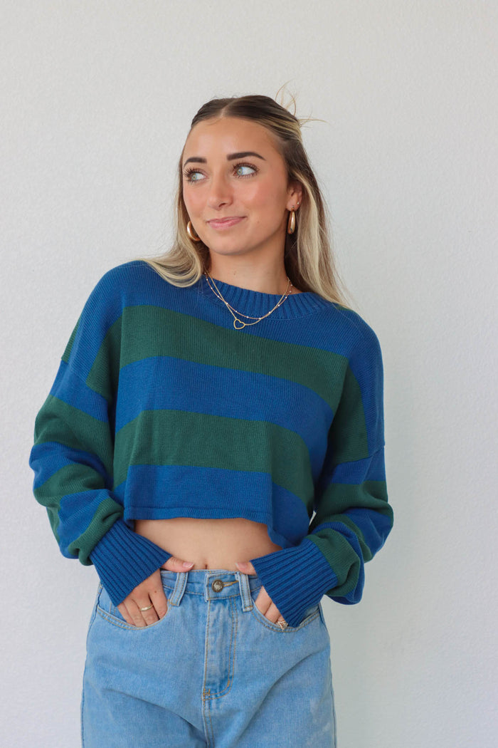 girl wearing blue and green striped knit cropped sweater