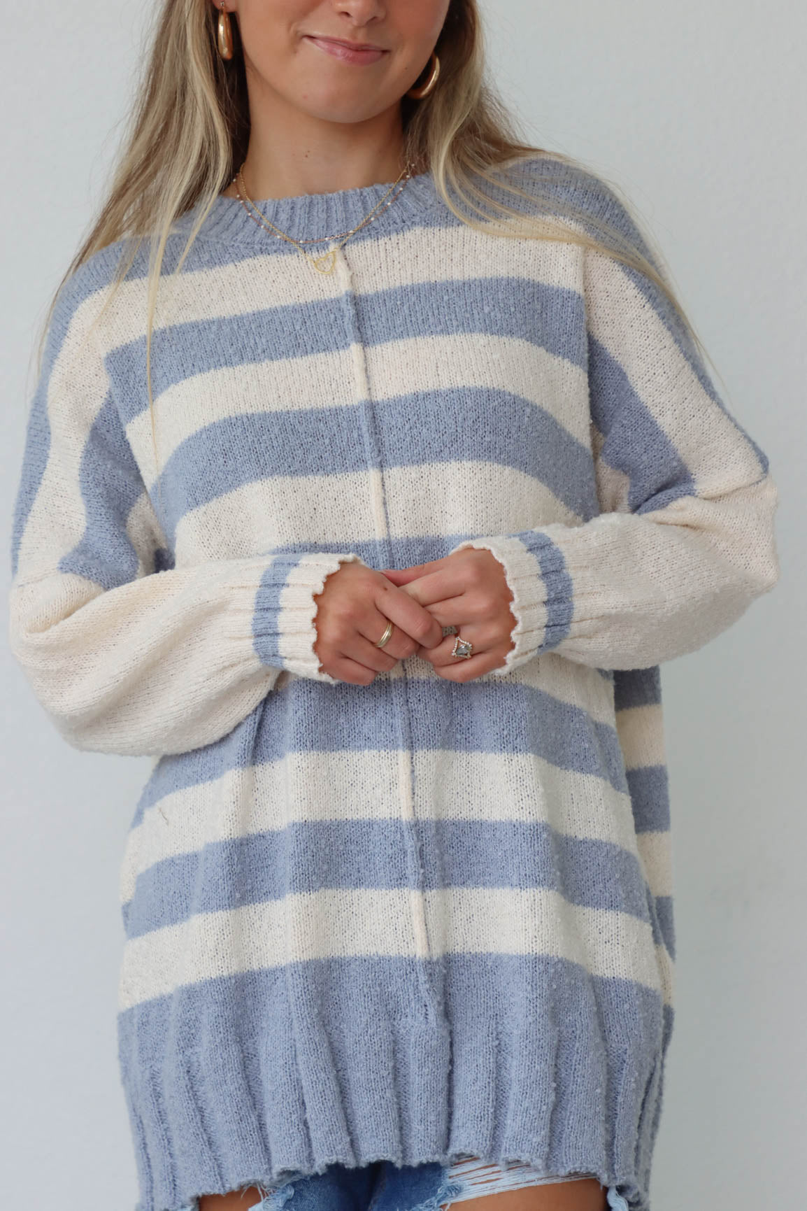 girl wearing blue & cream striped sweater