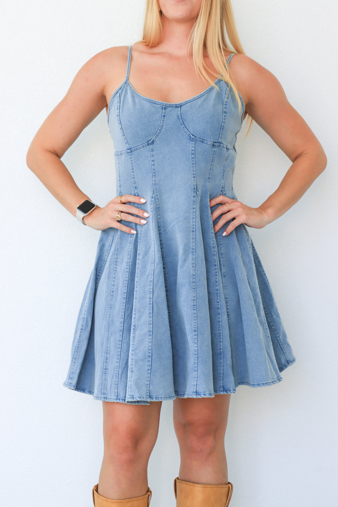 Woman wearing a denim dress with a white background