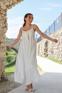 girl wearing white long maxi dress with bow detailing